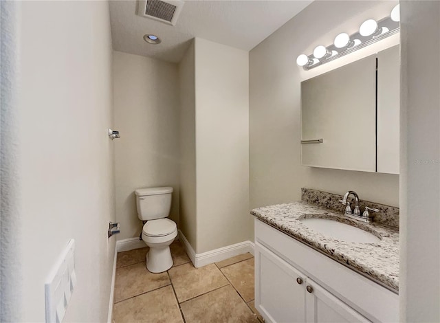 bathroom featuring vanity, toilet, and tile patterned floors