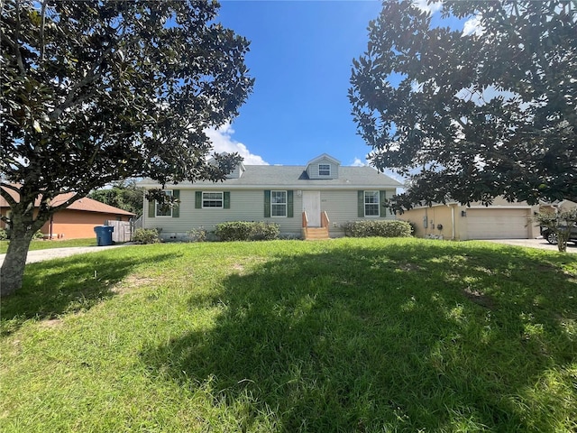 single story home with a front yard and a garage