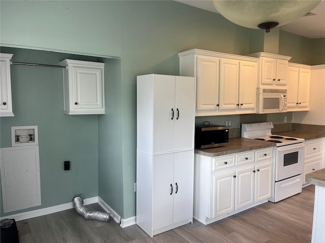 kitchen with light hardwood / wood-style flooring, white cabinetry, and white appliances