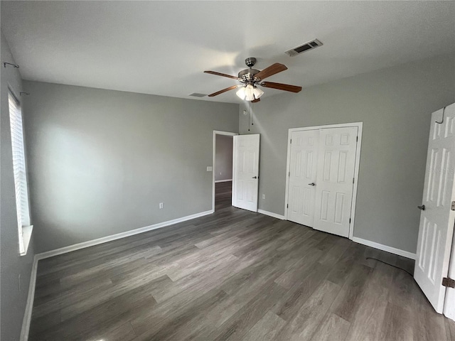 unfurnished bedroom featuring a closet, ceiling fan, and dark hardwood / wood-style floors