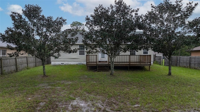 rear view of house featuring a yard and a wooden deck