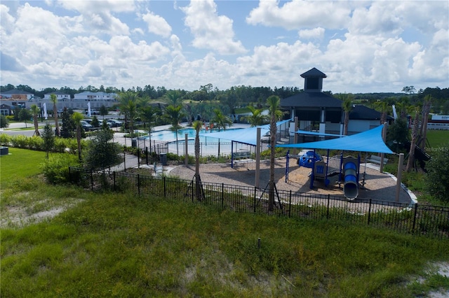 view of swimming pool with a playground