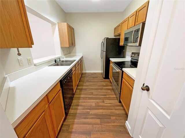 kitchen with hardwood / wood-style floors, stainless steel appliances, and sink