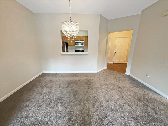 unfurnished room with a notable chandelier and carpet floors