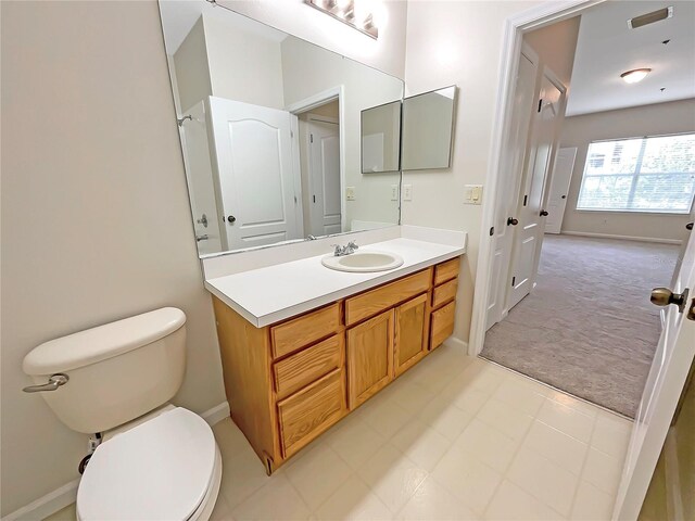 bathroom featuring toilet and vanity