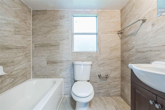 bathroom featuring vanity, toilet, and tile walls