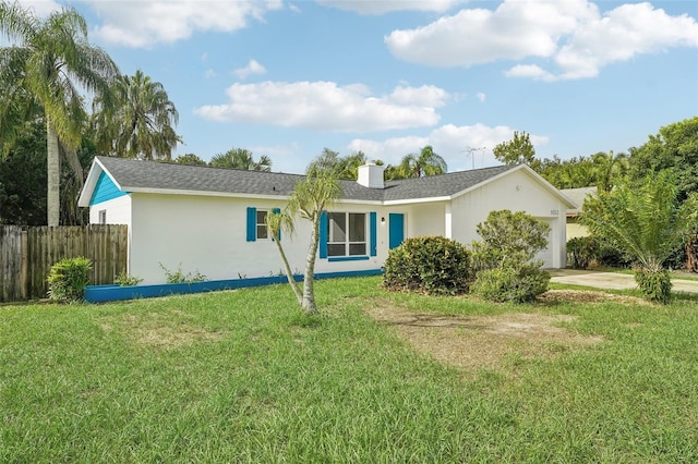 view of front facade featuring a front lawn and a garage