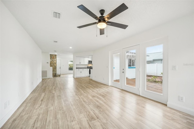 unfurnished living room featuring light wood-type flooring and ceiling fan