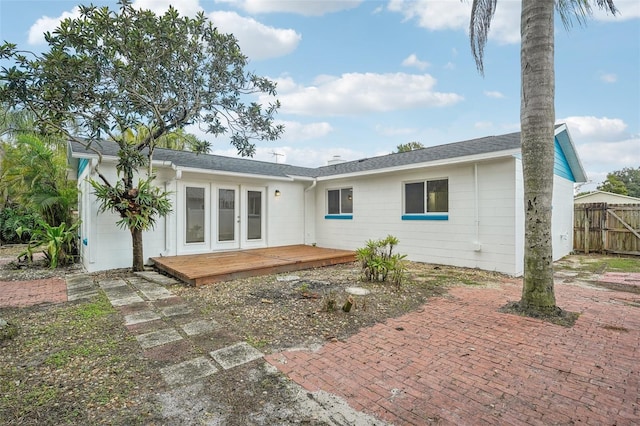 back of property with a wooden deck and french doors