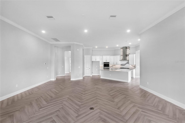 unfurnished living room featuring crown molding, light parquet floors, and sink