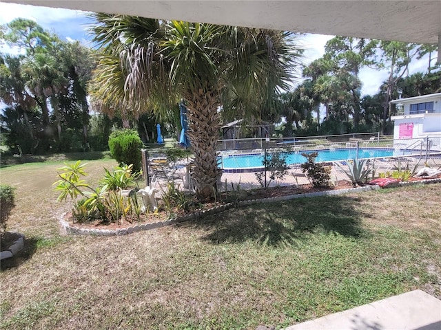 view of pool featuring a yard