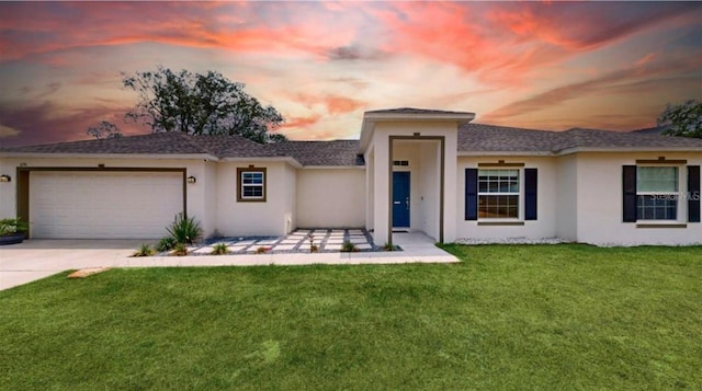 prairie-style house featuring a yard and a garage