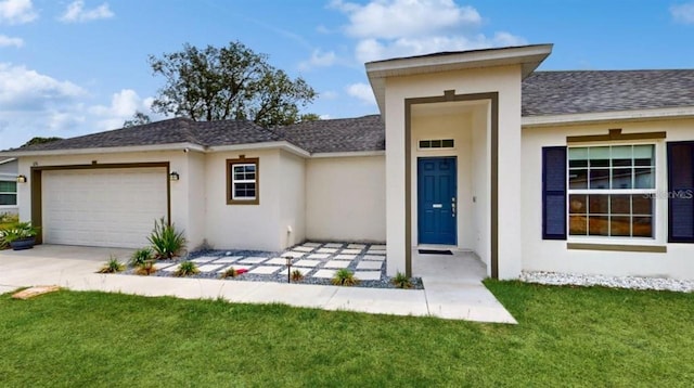 view of front facade with a garage and a front lawn