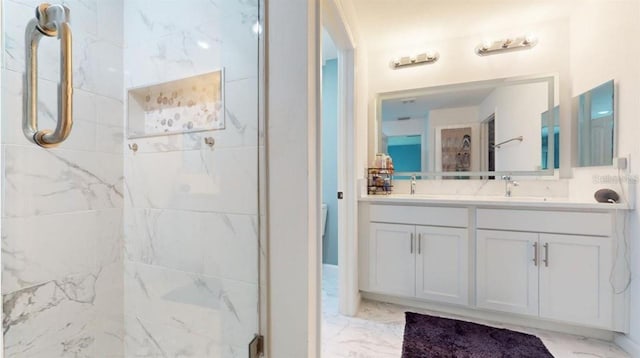 bathroom with vanity and a tile shower