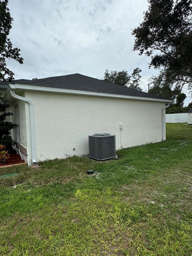 view of home's exterior featuring a lawn and cooling unit