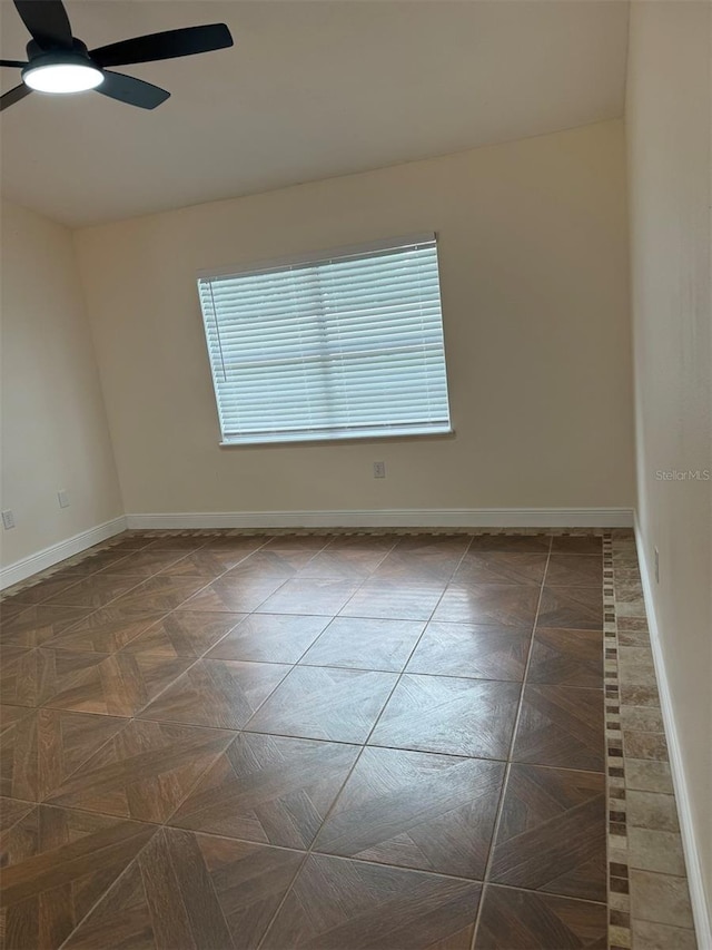 unfurnished room featuring dark parquet flooring and ceiling fan