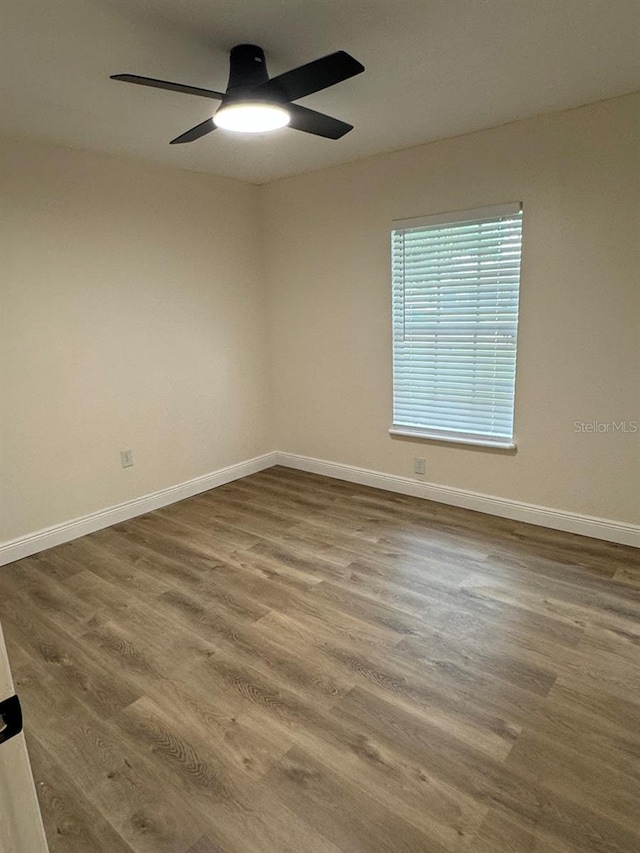 unfurnished room with hardwood / wood-style flooring and ceiling fan