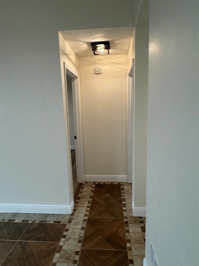 corridor featuring dark tile patterned flooring