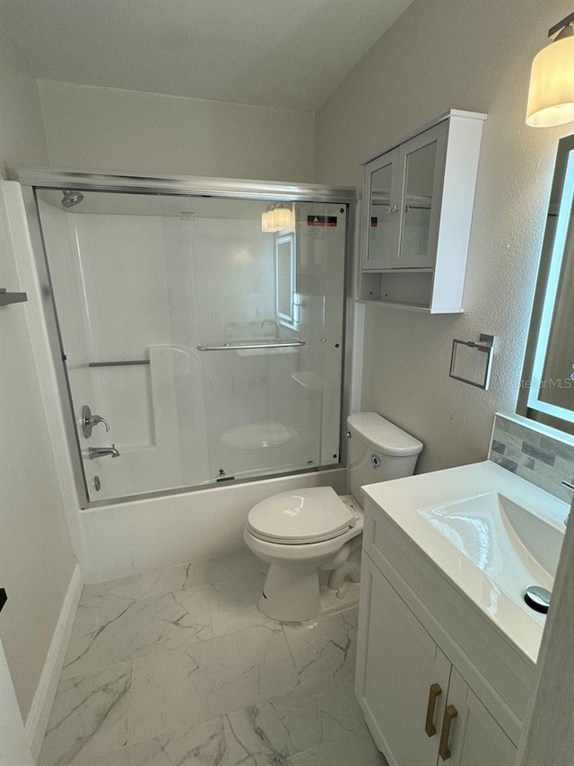 full bathroom featuring toilet, vanity, and combined bath / shower with glass door