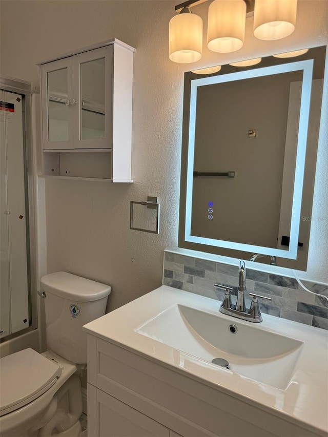 full bathroom featuring decorative backsplash, vanity, combined bath / shower with glass door, and toilet