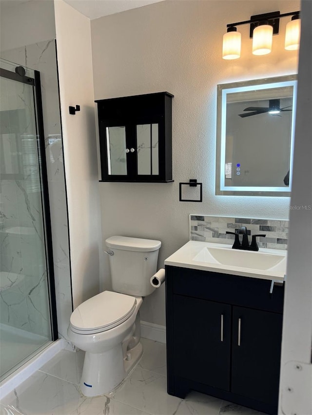 bathroom featuring decorative backsplash, vanity, toilet, and a shower with door