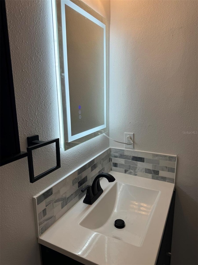 bathroom featuring decorative backsplash and vanity