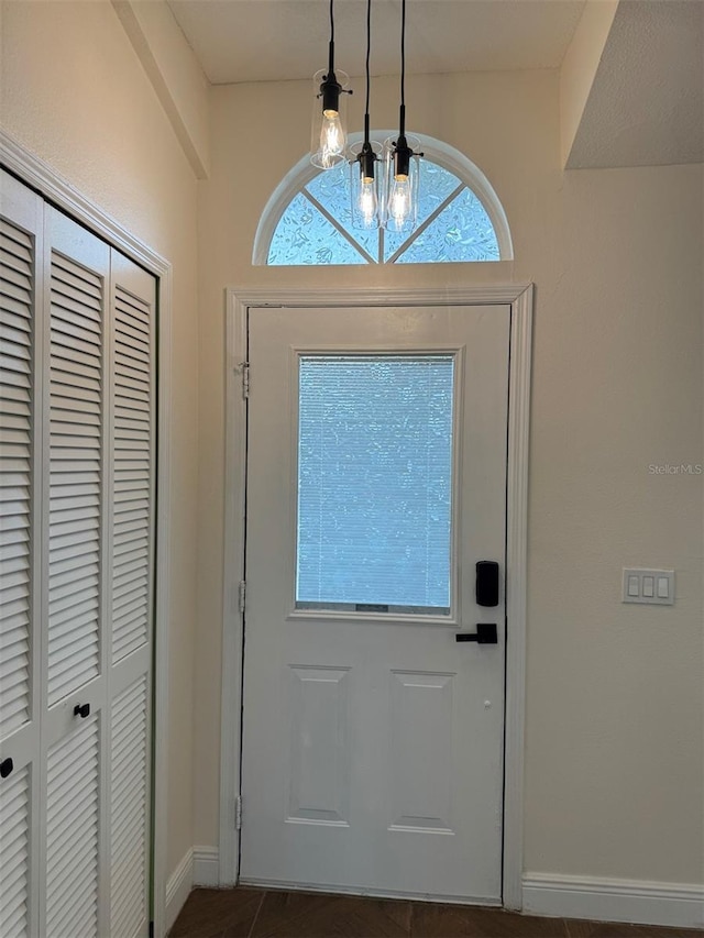 doorway with a notable chandelier