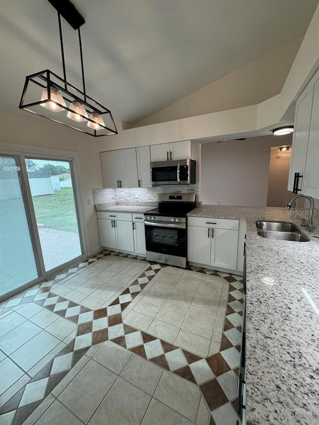 kitchen featuring white cabinetry, sink, decorative light fixtures, light tile patterned floors, and appliances with stainless steel finishes