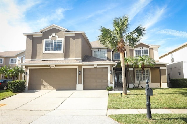 view of front of property featuring a front yard and a garage