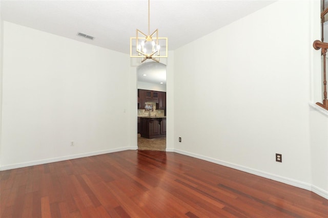 interior space with hardwood / wood-style floors and an inviting chandelier