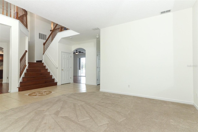 unfurnished room featuring ceiling fan and light colored carpet