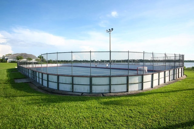 view of pool with a yard and tennis court