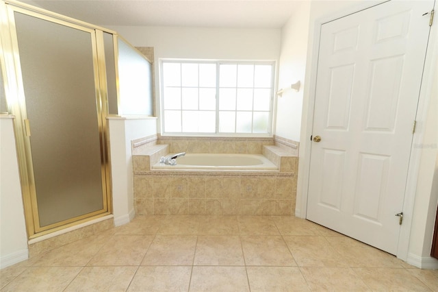 bathroom with tile patterned floors and shower with separate bathtub