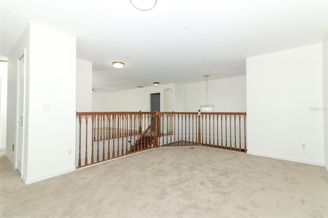 unfurnished room featuring light carpet