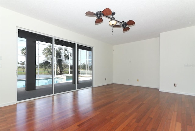 unfurnished room with ceiling fan, dark hardwood / wood-style flooring, and a textured ceiling