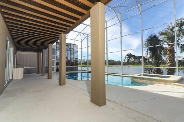 view of swimming pool with an in ground hot tub, a patio, a water view, and glass enclosure