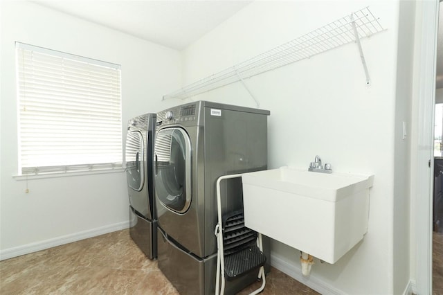 laundry room with washing machine and dryer and sink