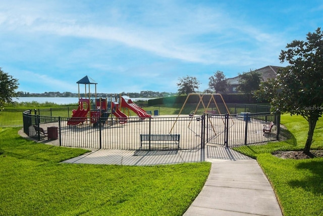 view of play area featuring a water view and a yard