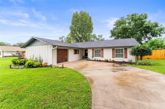 ranch-style house with a garage and a front yard