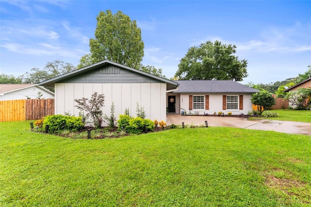 ranch-style home featuring a front lawn and a patio