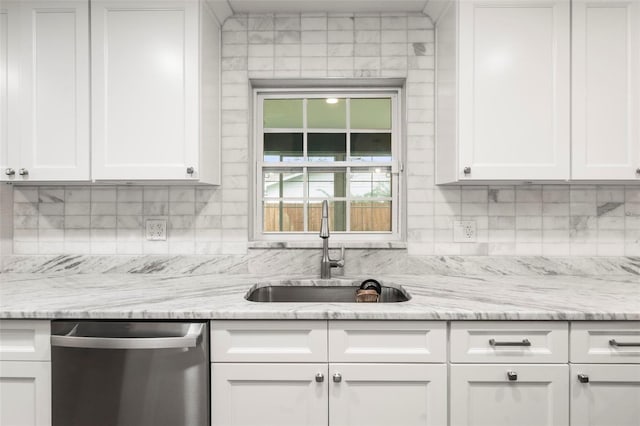 kitchen with white cabinets, sink, and stainless steel dishwasher