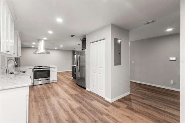 kitchen with island range hood, sink, appliances with stainless steel finishes, and white cabinetry