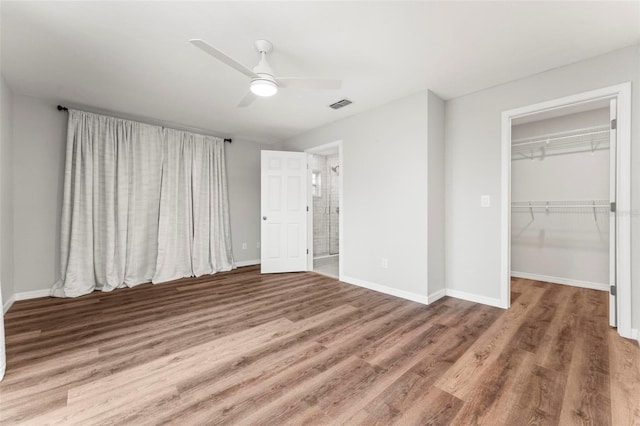 unfurnished bedroom featuring ceiling fan, a closet, and wood-type flooring