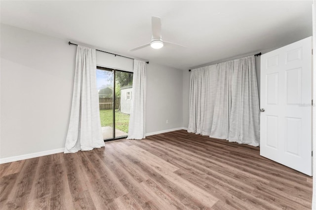 empty room featuring wood-type flooring and ceiling fan