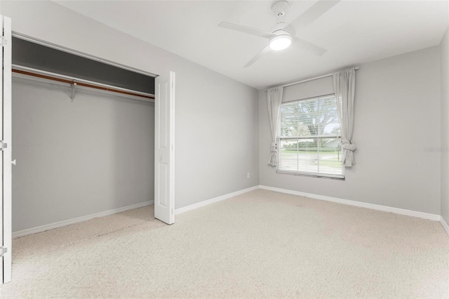 unfurnished bedroom with a closet, ceiling fan, and light colored carpet