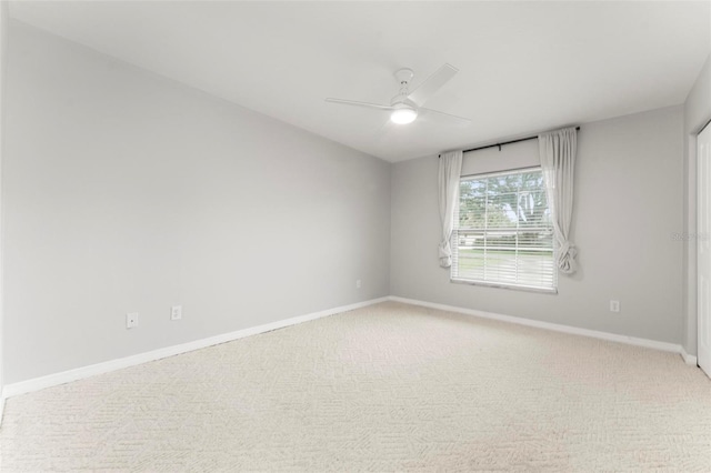 spare room featuring ceiling fan and light carpet