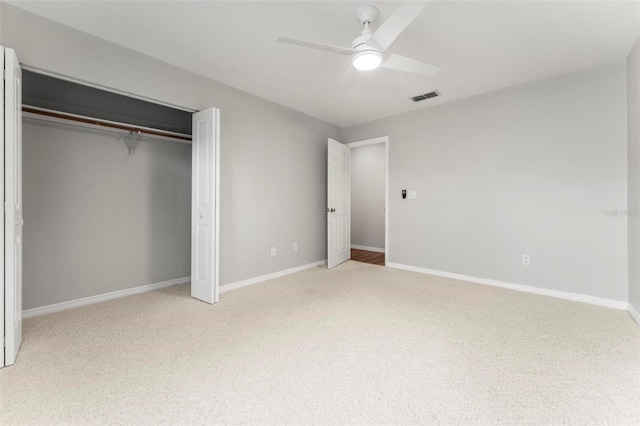 unfurnished bedroom featuring carpet flooring, ceiling fan, and a closet