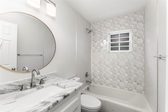 full bathroom featuring tiled shower / bath, toilet, and vanity