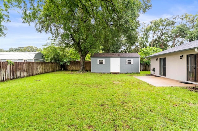 view of yard with a shed and a patio