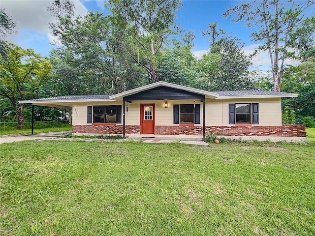 ranch-style home with a front lawn and a carport